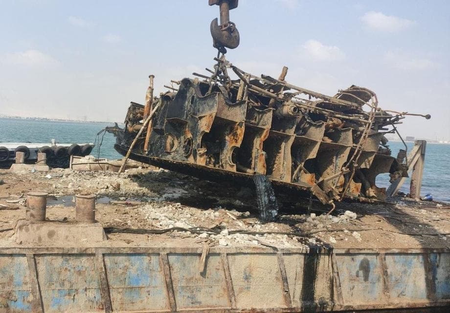 Crane and salvage team recovering a wrecked vessel during a marine salvage operation